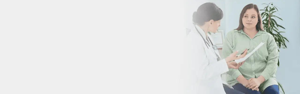 A doctor reviews an online weight loss consultation for a patient